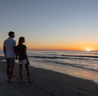 couple watching the sunrise at the beach