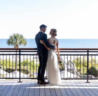 couple standing on an outdoor balcony
