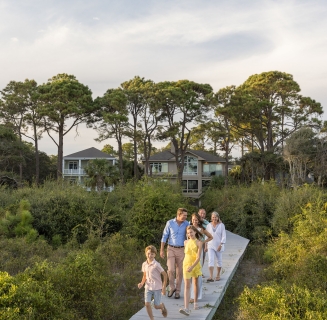 family walking on a boardwalk