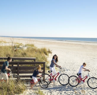 family going to the beach on biked