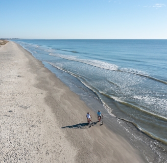couple biking on the beach
