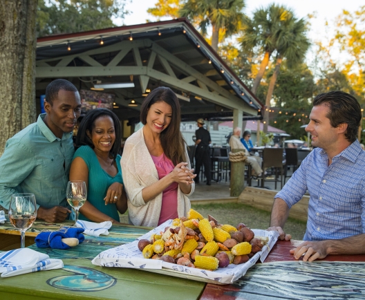 group of people around a table with a lowcountry boil