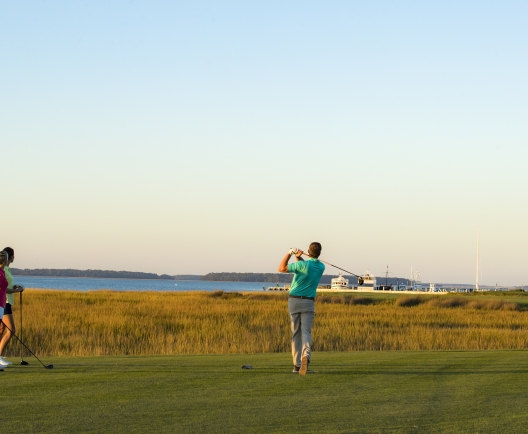 three people golfing