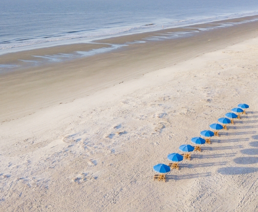 aerial shot of beach with umbrellas