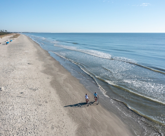 couple biking on the beach