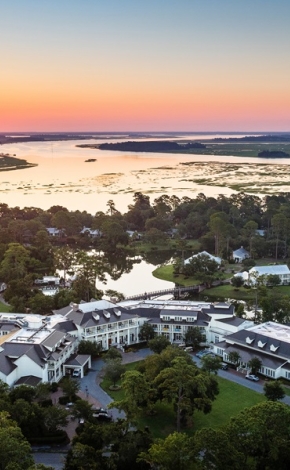 sunset with view of hotel and the water