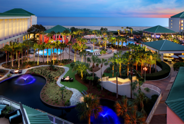 Aerial shot of resort featuring water features, outdoor pools, and patio areas