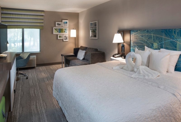 Hampton Inn room with towel swans on bed