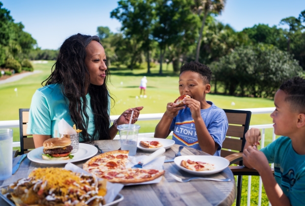 Mother and two sons eating on the patio at Big Jims