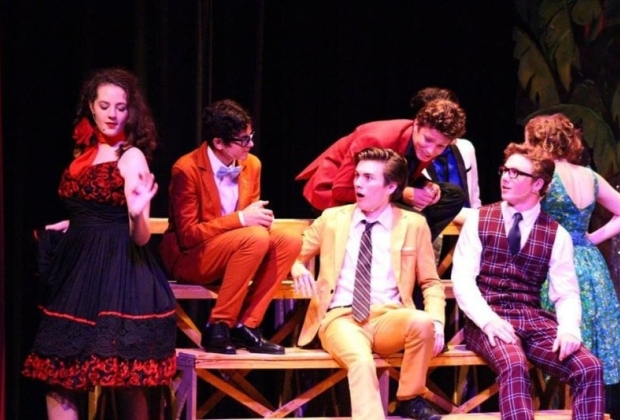 Actors on stage in costume mid scene
