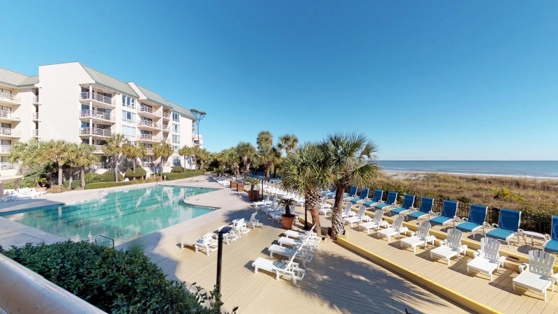 Long exposure of patio area with loungers set next to the outdoor pool