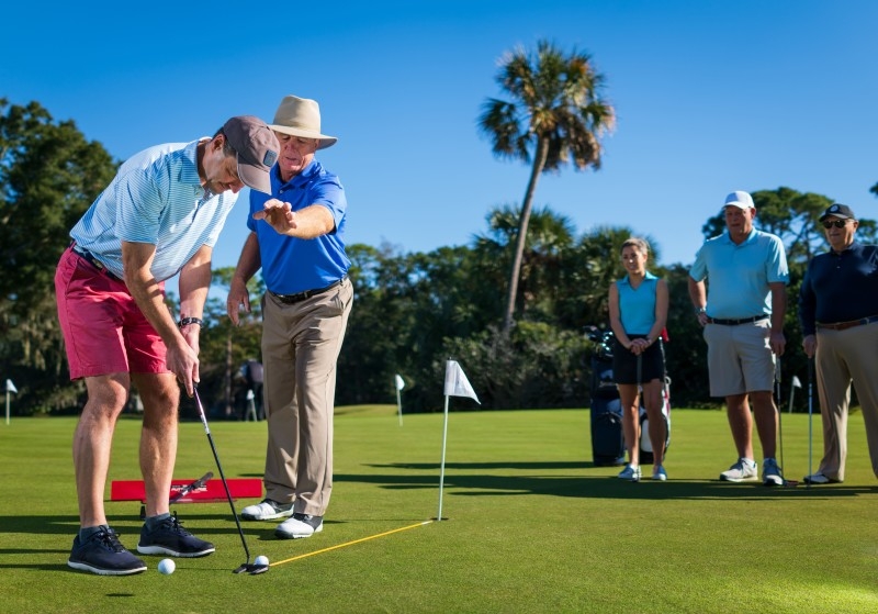 A golfer being instructed during swing