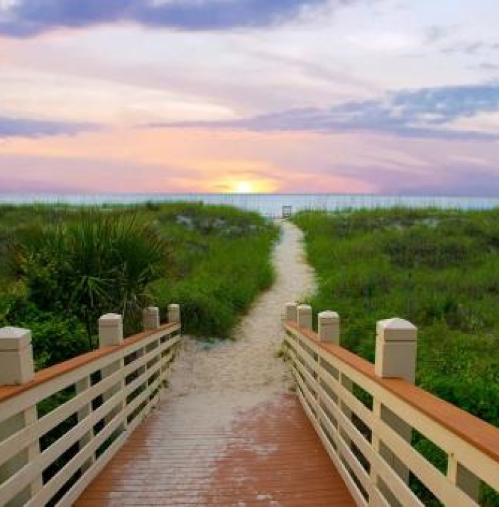 boardwalk leading to the beach at sunset